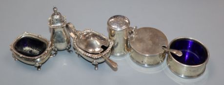 A George VI silver three piece condiment set, London 1945 and three other silver condiments.