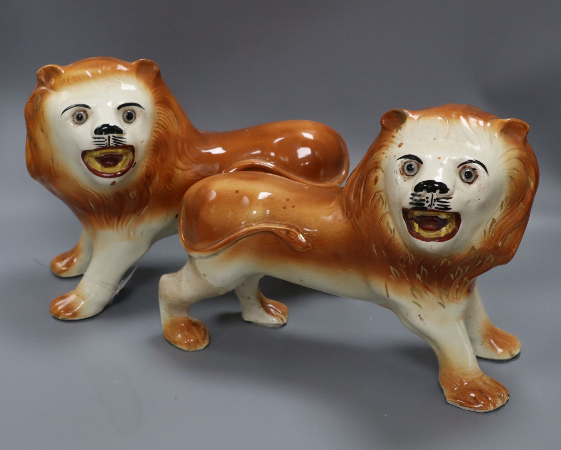 A pair of Staffordshire pottery figures of lions, 1910 width 32cm - Image 2 of 2