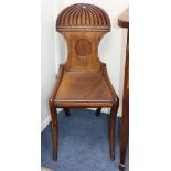 Two Regency carved mahogany hall chairs