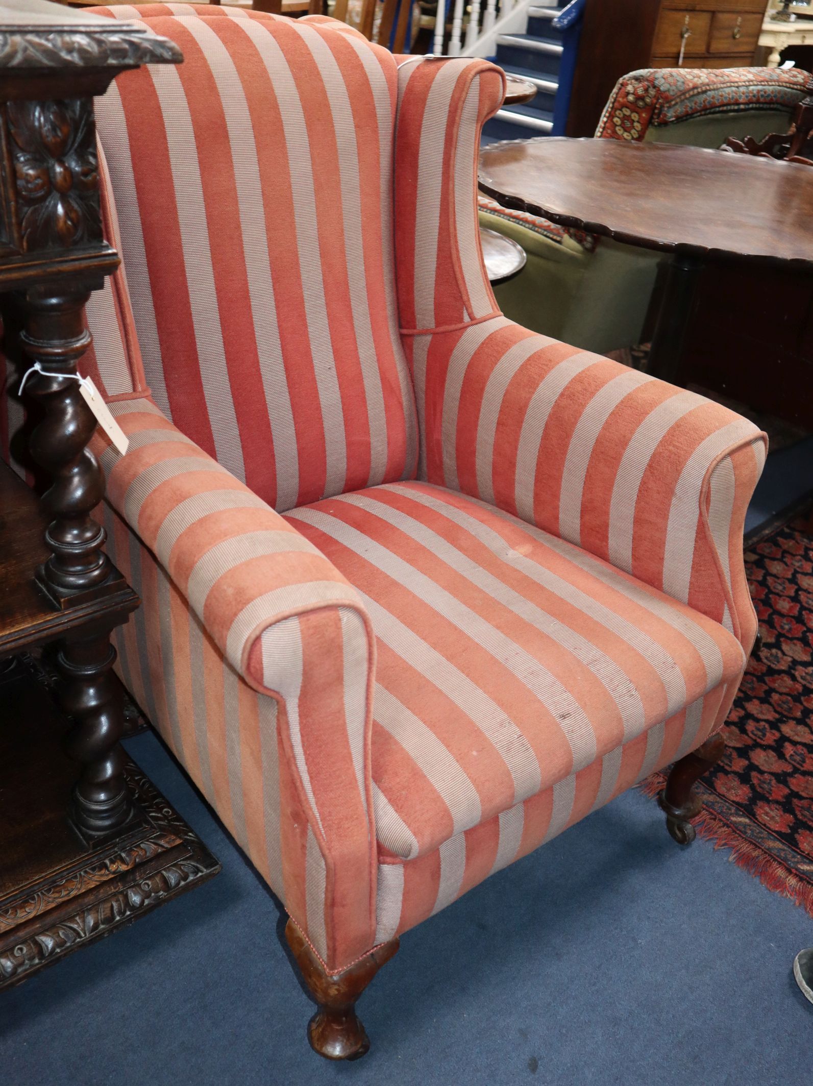 A pair 1920's upholstered wing armchairs