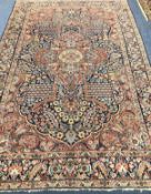 A Central Persian carpet with floral figured red ground central medallion on an all-over floral