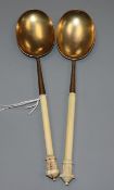 A near pair of Victorian ivory handled silver gilt serving spoons, John Edward Bingham, Sheffield,