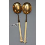 A near pair of Victorian ivory handled silver gilt serving spoons, John Edward Bingham, Sheffield,