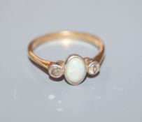 An 18ct & plat, three stone white opal and diamond dress ring, size L.