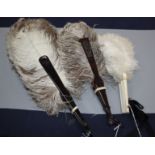 Two female ostrich feather fans and a small white ostrich feather fan, the former with faux-