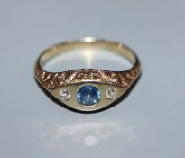 A 14k yellow metal, gypsy set sapphire and diamond three stone ring, size M.