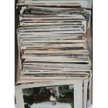 A scrap album and quantity of postcards