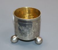 A late 18th century Russian white metal tot beaker on ball feet, dated 1781, 5cm.