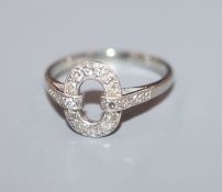An 18ct, plat and diamond set openwork oval dress ring, size L.