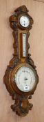 A late Victorian oak aneroid barometer, thermometer and timepiece H.89cm