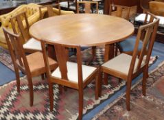 A Gordon Russell oak drop flap dining table and eight Enstone oak chairs