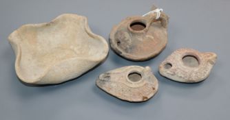 Three Roman pottery oil lamps and a Palestinian dish, circa 2000BC