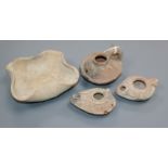Three Roman pottery oil lamps and a Palestinian dish, circa 2000BC