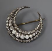 A paste-set white metal crescent brooch, stamped 900, 35mm.