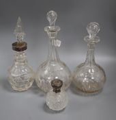 Three cut glass decanters and a silver mounted scent bottle