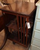 An Edwardian style mahogany and satinwood revolving open bookcase W.45cm