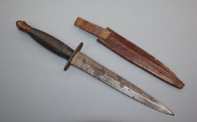 J. Nowill & Sons, A commando fighting knife, ribbed grip and 17cm spear point blade with leather