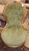 A Victorian carved walnut nursing chair