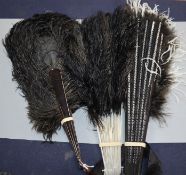 A black and white ostrich feather fan and two black ostrich feather fans, the former with silver