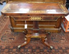 A Regency rosewood card table inlaid with cut brass-work, on square pillar and quadripartite base (