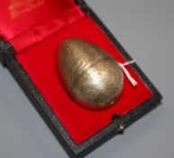 A Stuart Devlin Surprise Egg in silver gilt and enamel, opening to reveal a frog on a lily pad, on