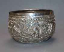 A late 19th/early 20th century Burmese white metal small bowl embossed with animals, diameter approx