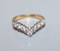 An 18ct gold nine-stone diamond 'V' shaped ring, size H/I.