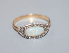 A 1920's yellow metal, white opal and rose cut diamond set ovoid dress ring, size O.