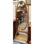 An Edwardian mahogany cheval mirror having oval plate H.176cm