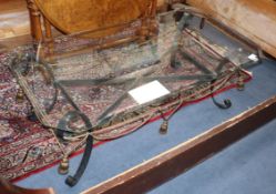 A glass top wrought iron coffee table L.122cm