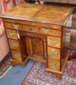 A George II style walnut kneehole desk W.74cm