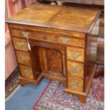 A George II style walnut kneehole desk W.74cm