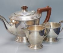 A George V Art Deco silver three-piece tea service of circular form Birmingham 1935, Makers Mappin &