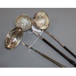 A Georgian coin-set toddy ladle with plain oval bowl and whalebone handle and two other toddy ladles