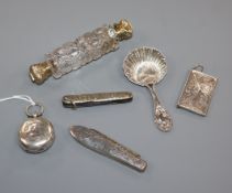 A Victorian gilt white metal and glass double scent bottle, a sovereign case, a caddy spoon, a stamp