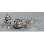 Two George silver mustard pots and a similar pepperettes.