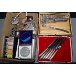 Two cased sets of six silver-handled butter knives and sundries, including a silver-topped condiment