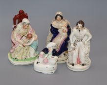 A Staffordshire figure of Queen Victoria, seated with baby and three other figures, comprising