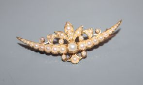 A yellow gold and split pearl set foliate crescent brooch, 54mm.