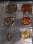 A collection of miscellaneous coins, including a Charles II gilded crown (modified as a brooch), a