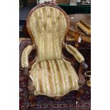 A Victorian carved walnut open armchair (a.f.) and a Victorian carved walnut nursing chair