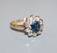 An 18ct gold,, sapphire and diamond oval cluster ring, size K.