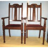 A pair of oak Art Nouveau elbow chairs