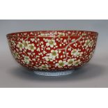 A Chinese bowl decorated with prunus on a scarlet ground, Chenghua mark diameter 32cm