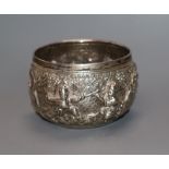 A rare Burmese white metal miniature bowl, embossed with figures in landscape scene, floral mark