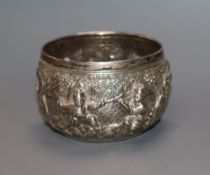 A rare Burmese white metal miniature bowl, embossed with figures in landscape scene, floral mark