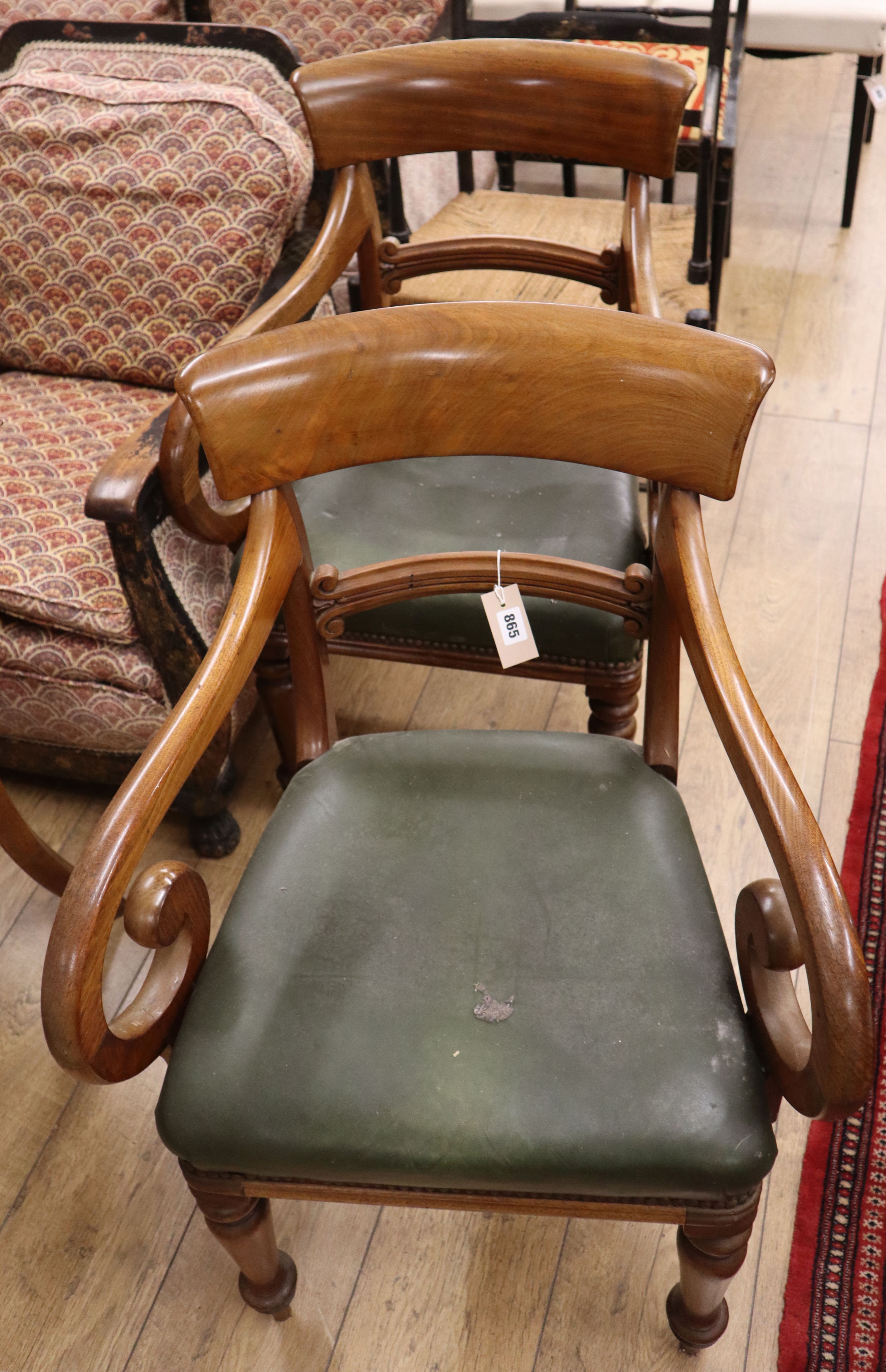 A pair of Regency mahogany scroll elbow chairs, with scroll arms