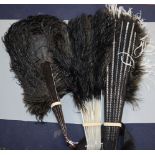 A black and white ostrich feather fan and two black ostrich feather fans, the former with silver