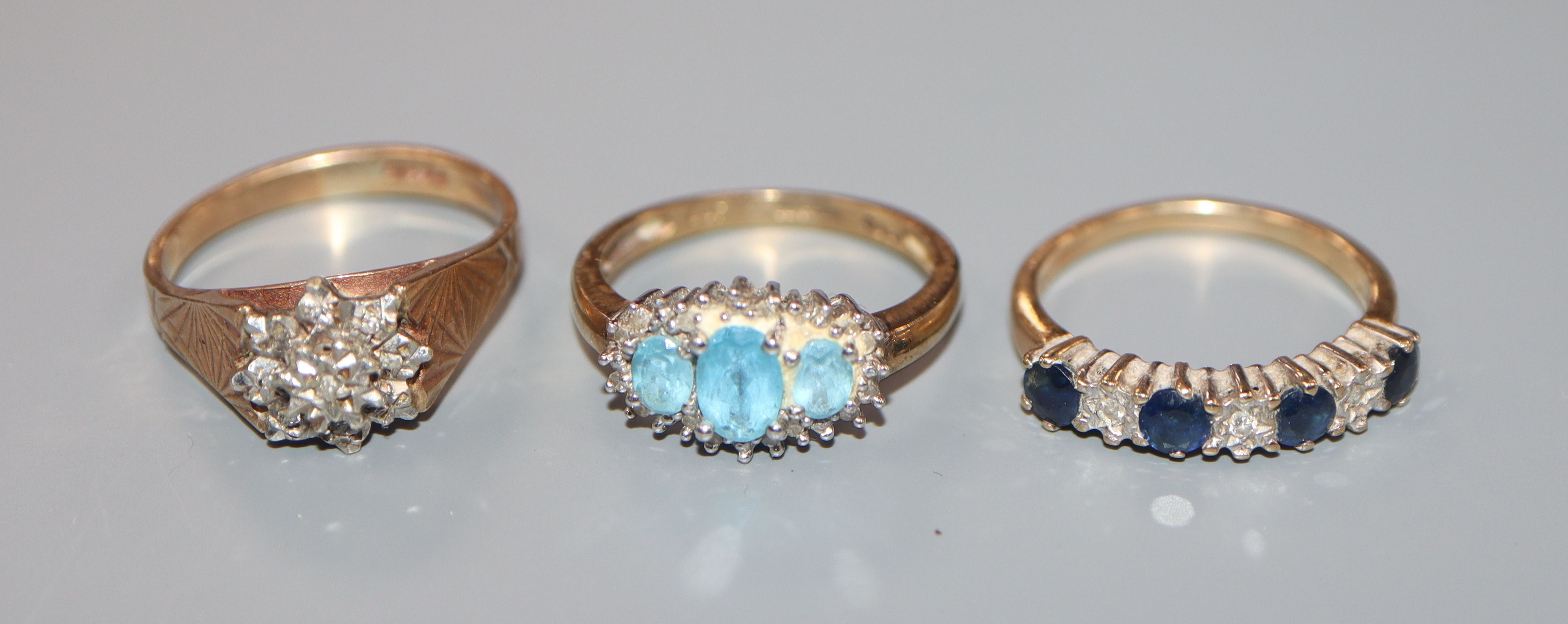Three assorted 9ct gold and gem set dress rings, including small illusion set diamond cluster.