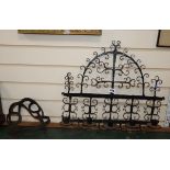A 17th century wrought iron wall sconce, an iron guard and a wrought iron roasting hanger